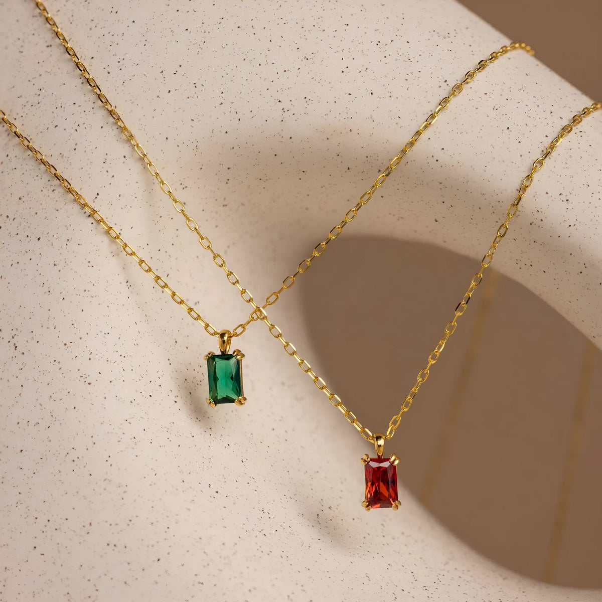 Titanium steel necklace with rectangular birthstone pendant and adjustable O-link chain on a neutral background.
