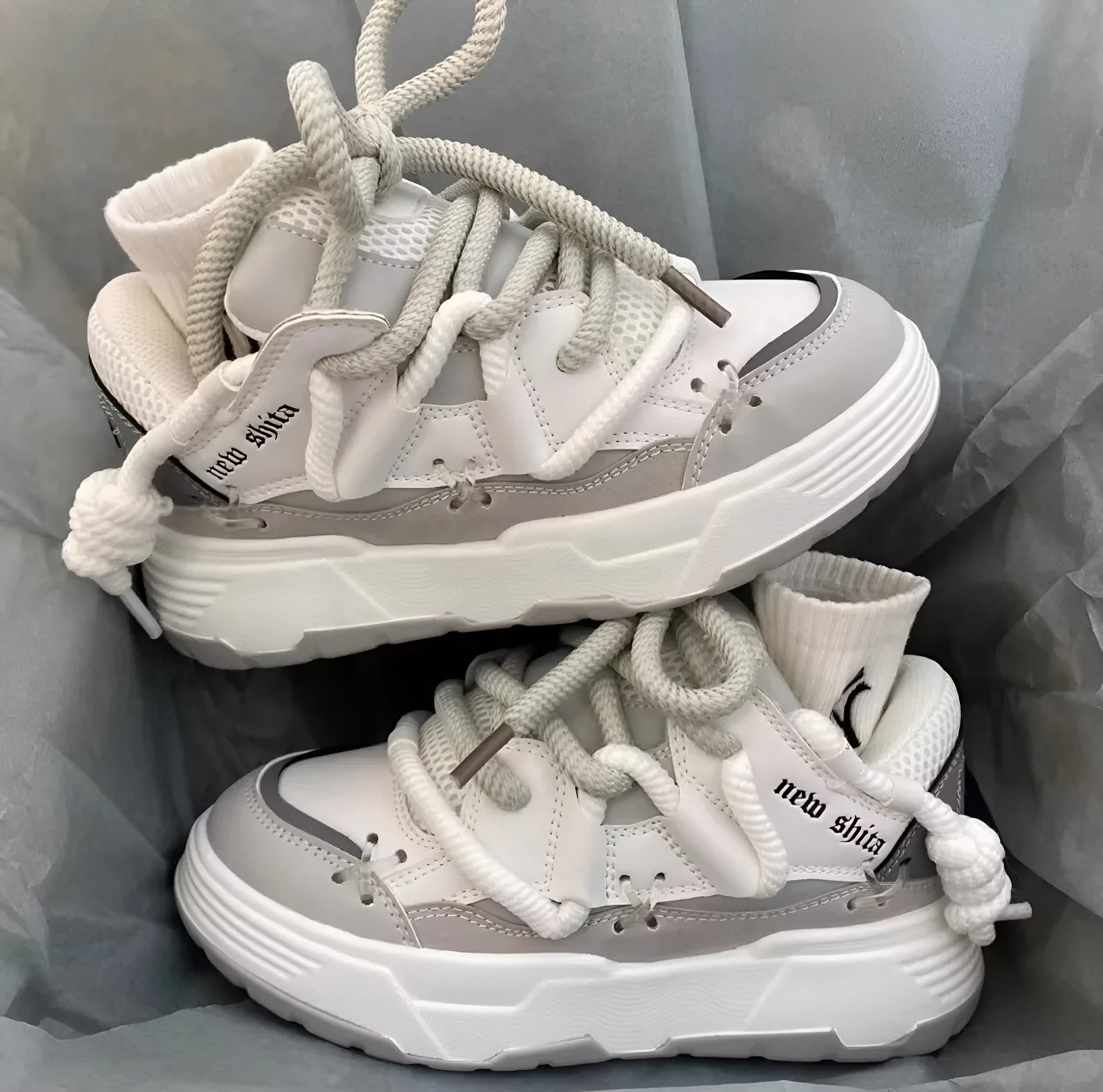 Women's grey retro chunky platform sneakers with thick rubber sole and lace-up design.