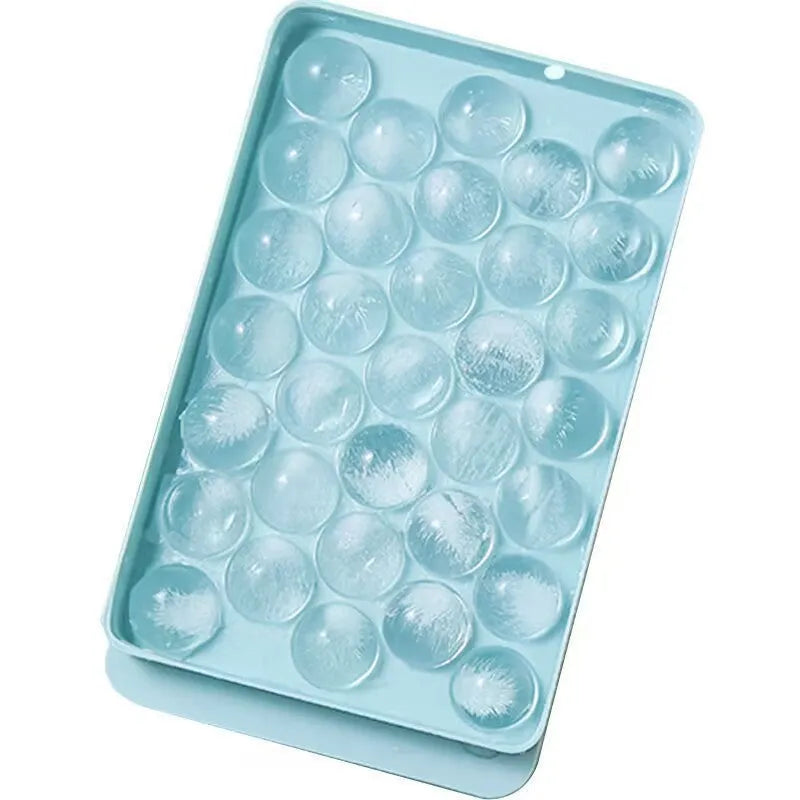 Blue silicone ice cube tray with lid showing 33 round compartments