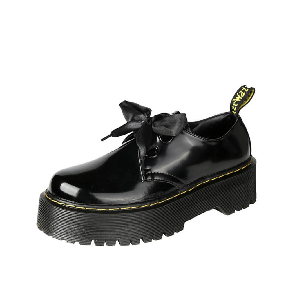 Black women's thick soled lace-up shoes with ribbon and cross strap detail on a superfine fibre upper.