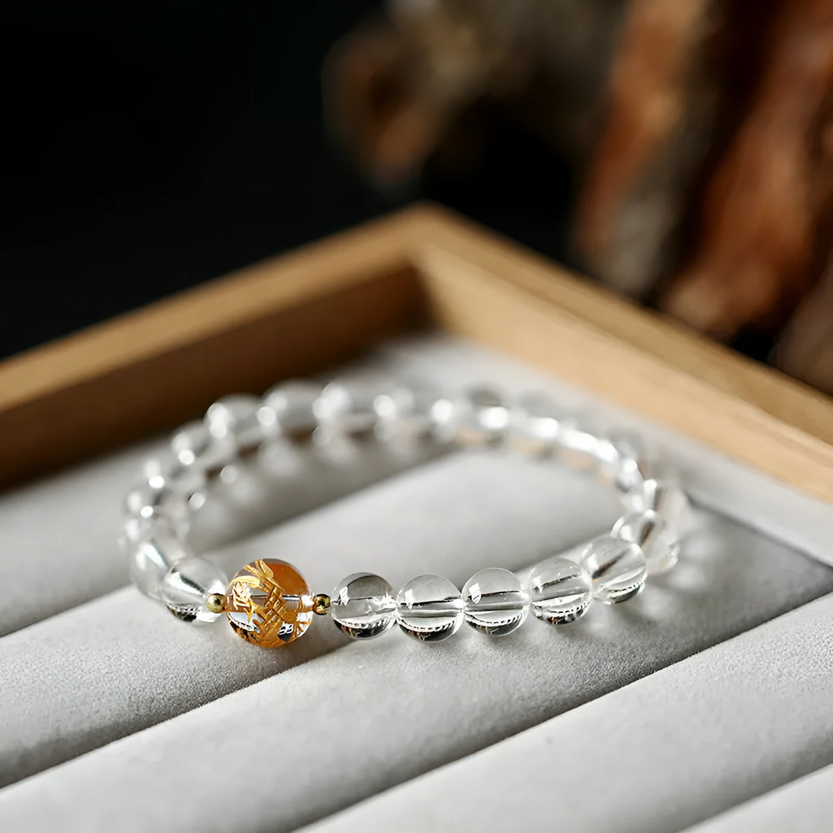 Geometric obsidian and white crystal bracelet with black agate beads and golden dragon charm on wrist