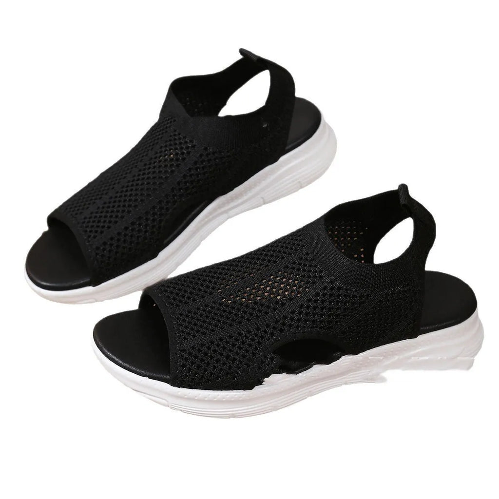 Women's platform sports sandals in black with a flat rubber sole and mesh lining.