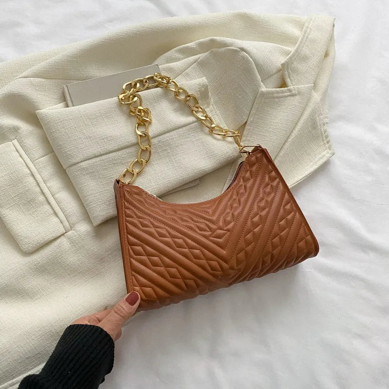 Brown pleated chain baguette shoulder bag showing vertical square shape and adjustable strap