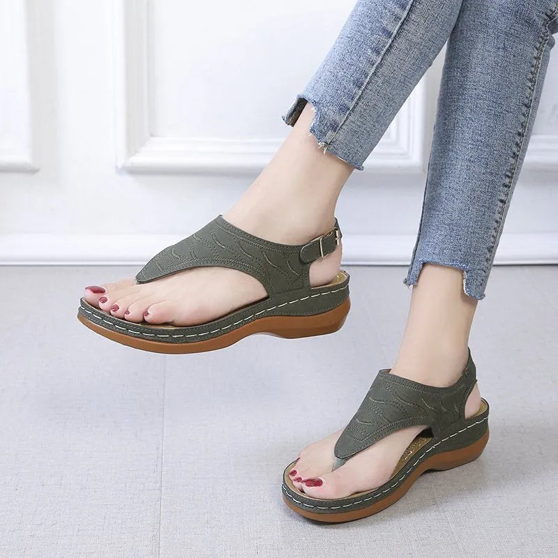 Women's wedge heel sandals with an adjustable buckle strap in a solid colour
