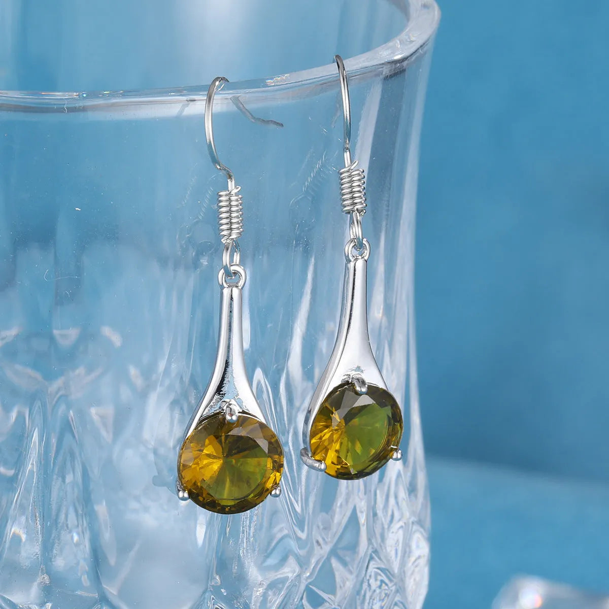 Olive green topaz drop earrings with minimalist water drop shape on alloy backing