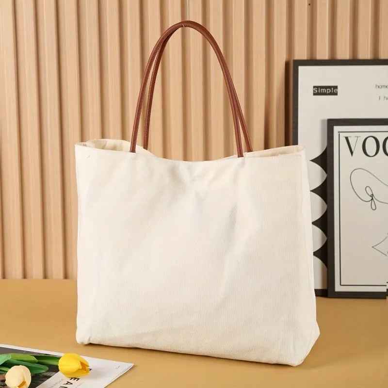 Large beige white canvas tote bag with a reinforced flat base and roomy interior.