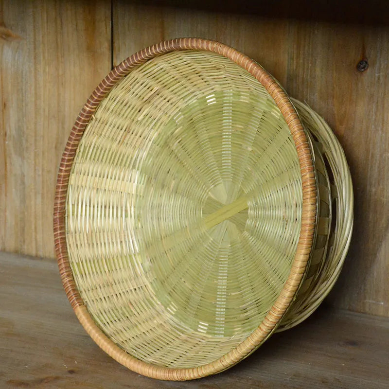 Handmade woven natural bamboo storage basket shown in a household setting.