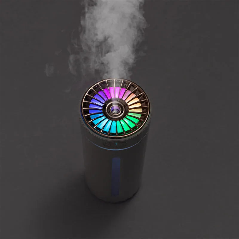 Black portable USB humidifier with colourful lights on car dashboard
