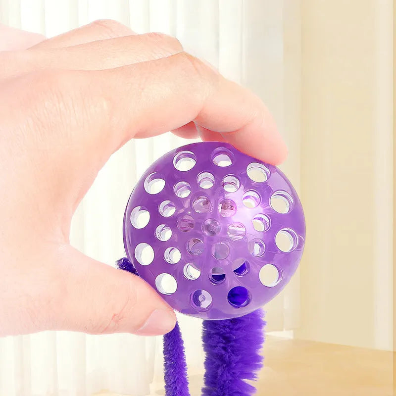 Green interactive bouncy ball cat toy with plush tail for indoor play