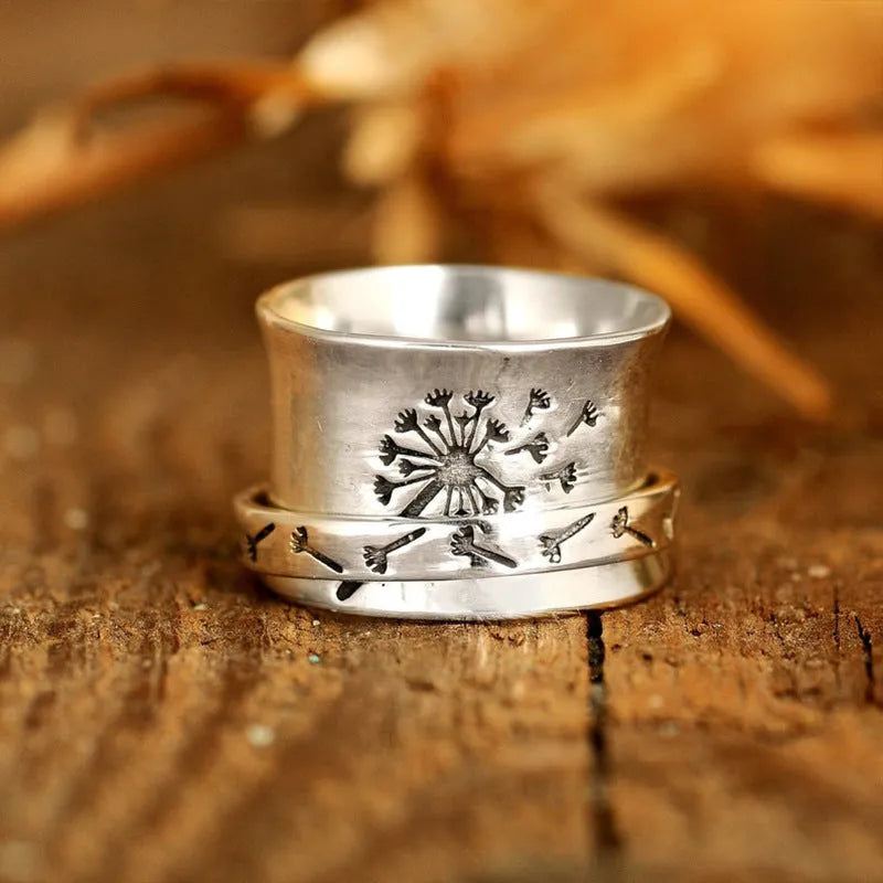 Silver rotatable flower ring showing petal detail and band, displayed with sizing options 7 through 11