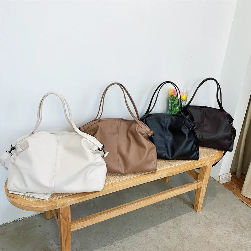 Large horizontal square soft PU messenger bag with zip and adjustable strap in four colour options.