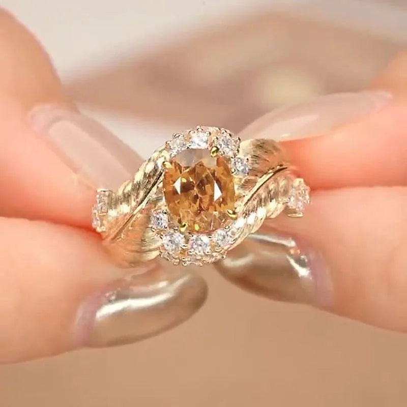 Copper feather embossed ring with yellow zircon stones, showing geometric design detail