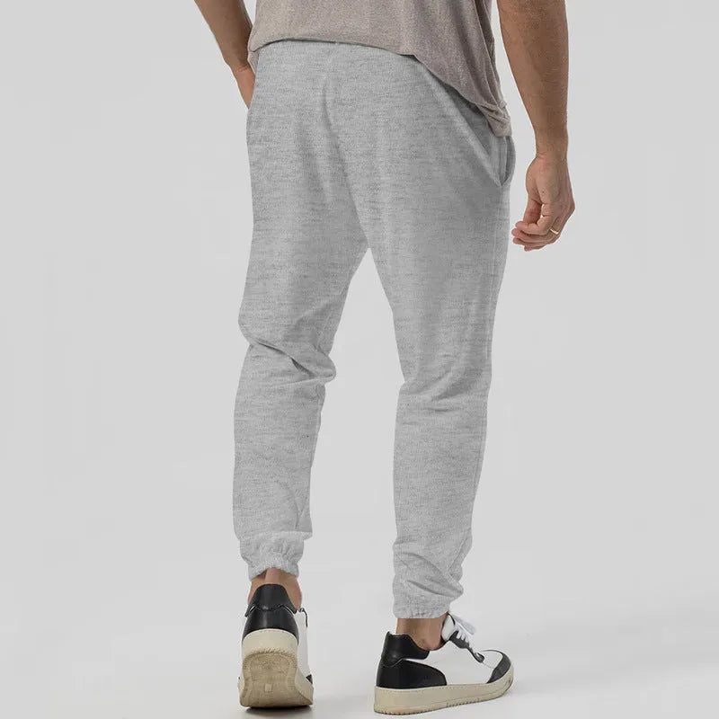 Men's straight-leg casual trousers in grey with tapered fit and elastic waistband