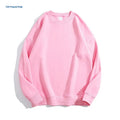 A woman wearing a loose-fit, off shoulder, long sleeve cotton pullover sweater in a solid colour.