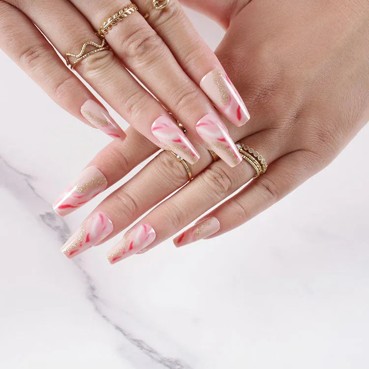 Wearable manicure set with 24 medium false nails in rose, tulip, leopard print, and XINGX patterns, plus glue.