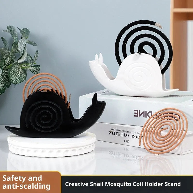 Black plastic mosquito incense holder with creative animal style on a flat surface