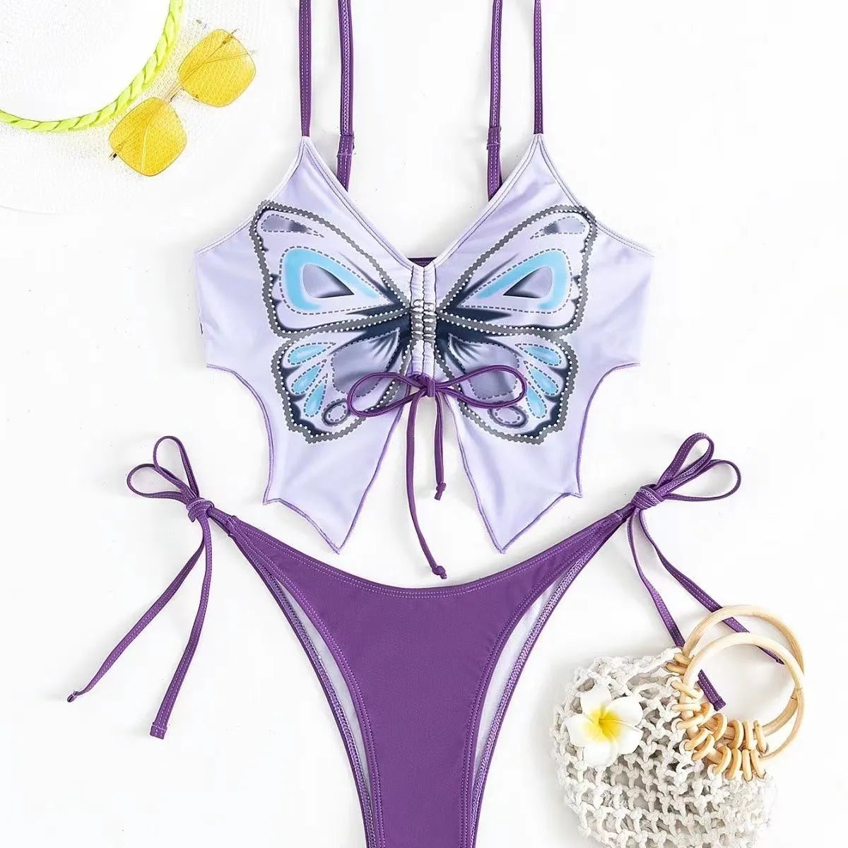 Women's purple bow ins style split bikini set with briefs, on a mannequin.