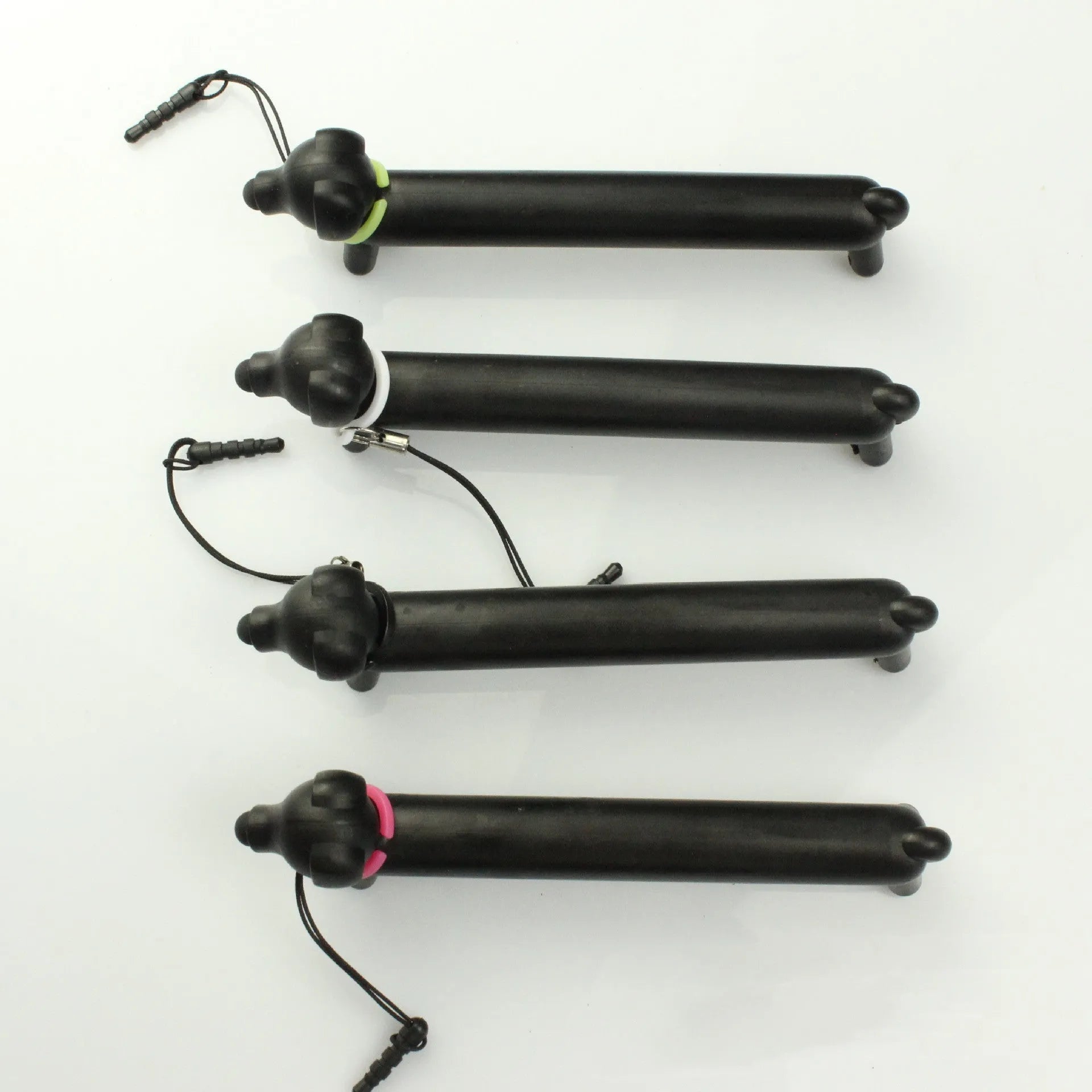 Black long puppy dog shaped touch screen stylus pen shown next to its carry socket