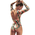 Women's floral leaf print backless one-piece swimsuit on a mannequin.