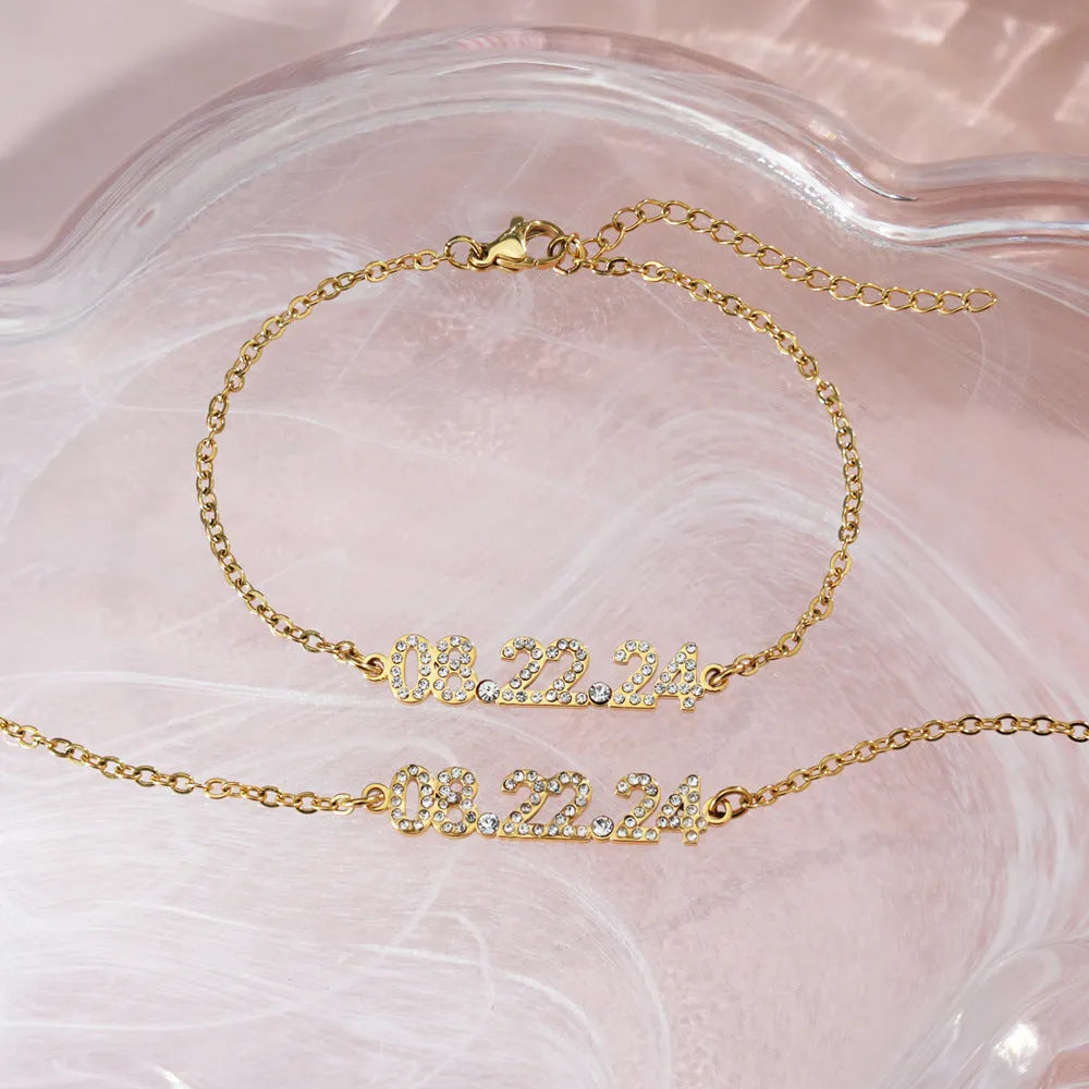 Stainless steel digital bracelet and necklace with diamonds on the numbers, shown in gold, rose gold and steel colour options.