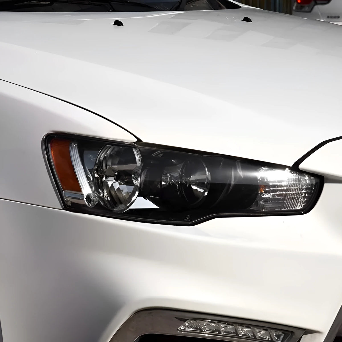 Transparent plastic headlight housing covers for driver and passenger positions
