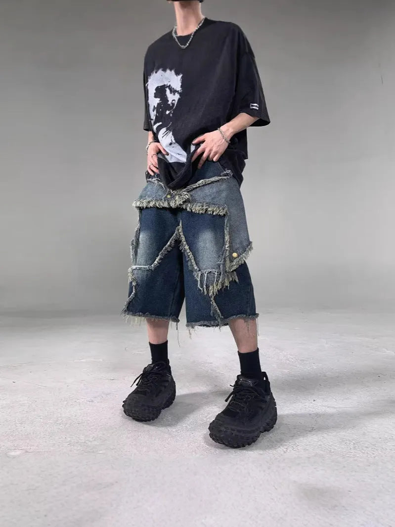 Blue American retro denim shorts with a frayed five-pointed star detail on the leg, shown in a loose fit.