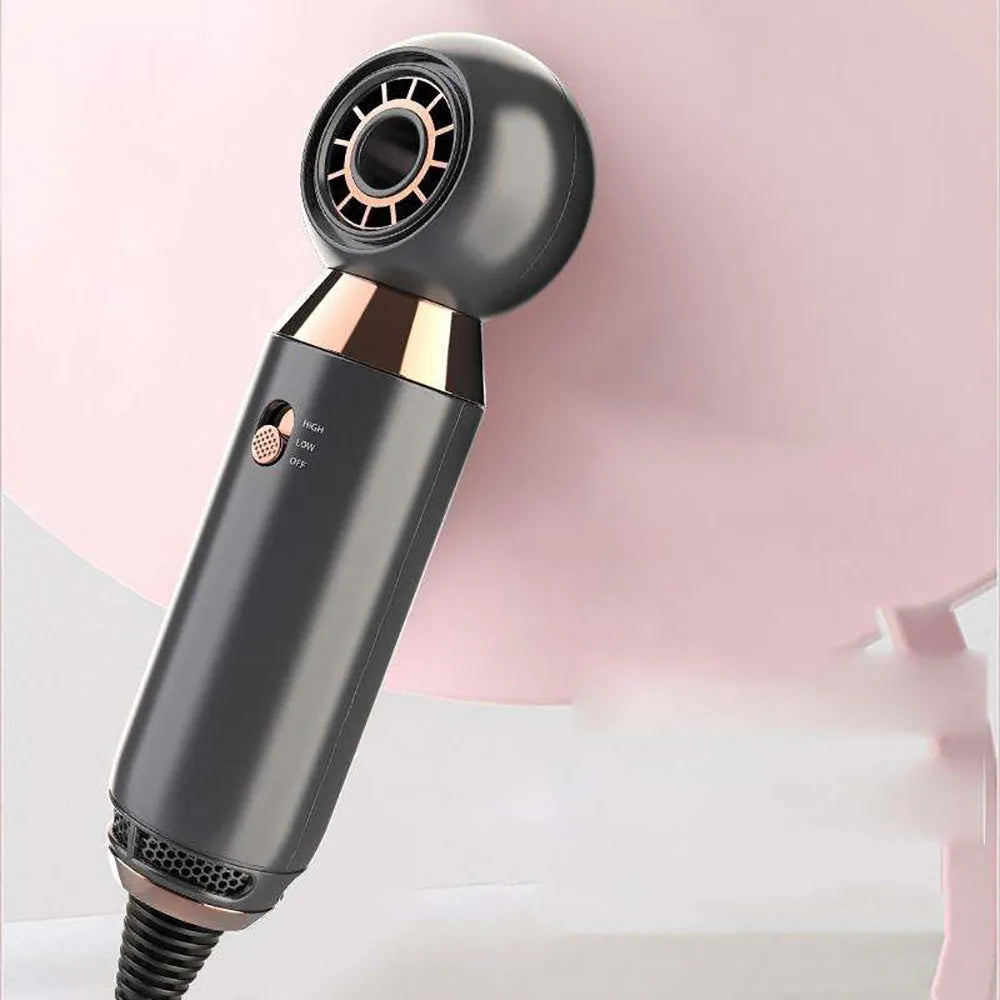 Compact leafless hair dryer with concentrator diffuser attachment on a white background.