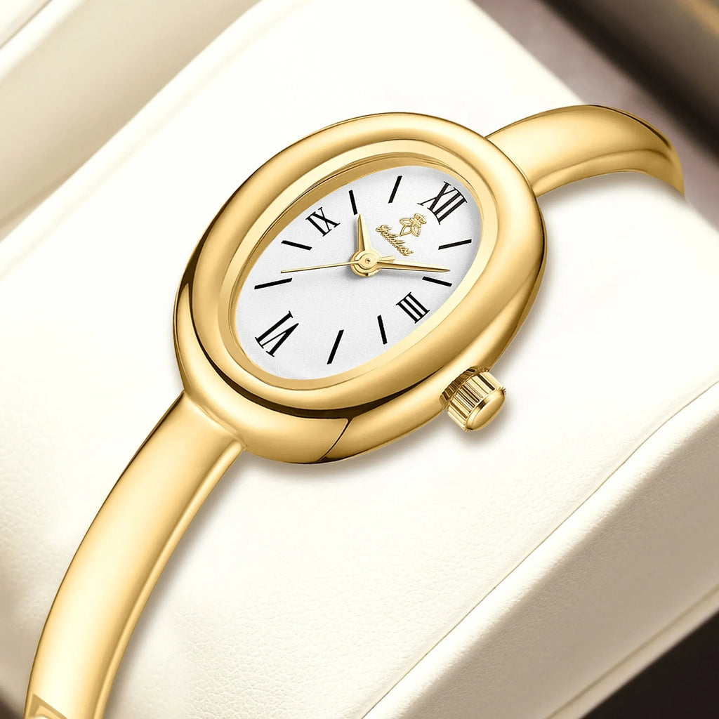Women's retro oval quartz watch in gold colour with spiral pattern design on wrist
